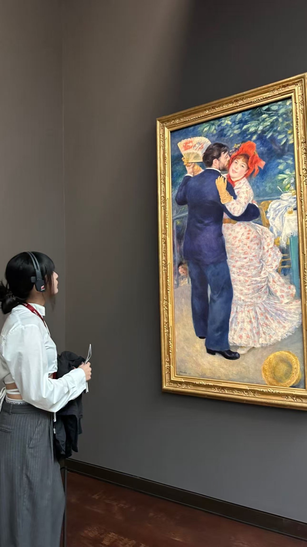 Sylvia viewing a Renoir painting